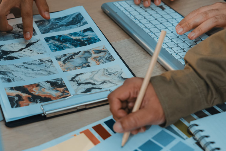 Engaging workspace with hands working on color palettes and textures for design projects